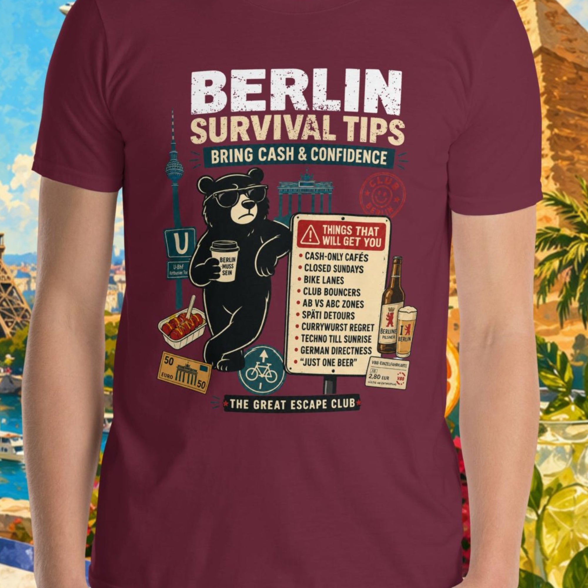Person wearing a maroon t-shirt with 'Berlin Survival Tips' design, set against a colorful background with landmarks and nature.