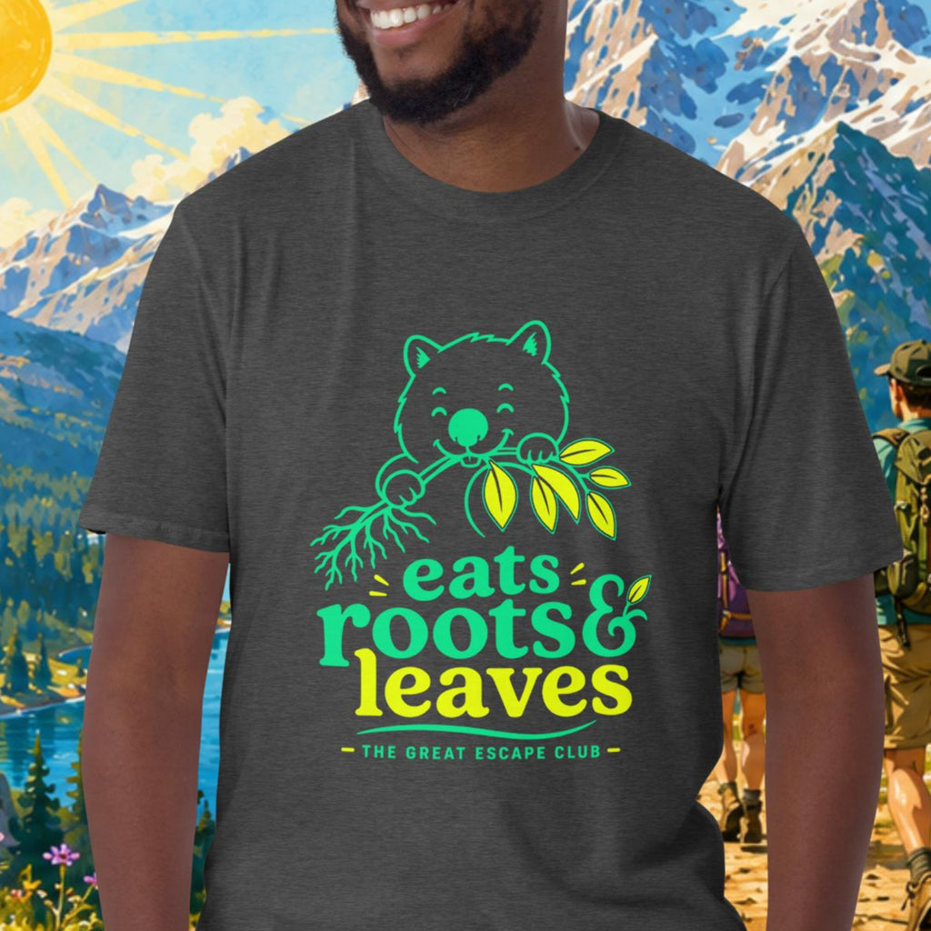 Man wearing a t-shirt with a bear graphic and text, standing in front of a scenic mountain landscape.