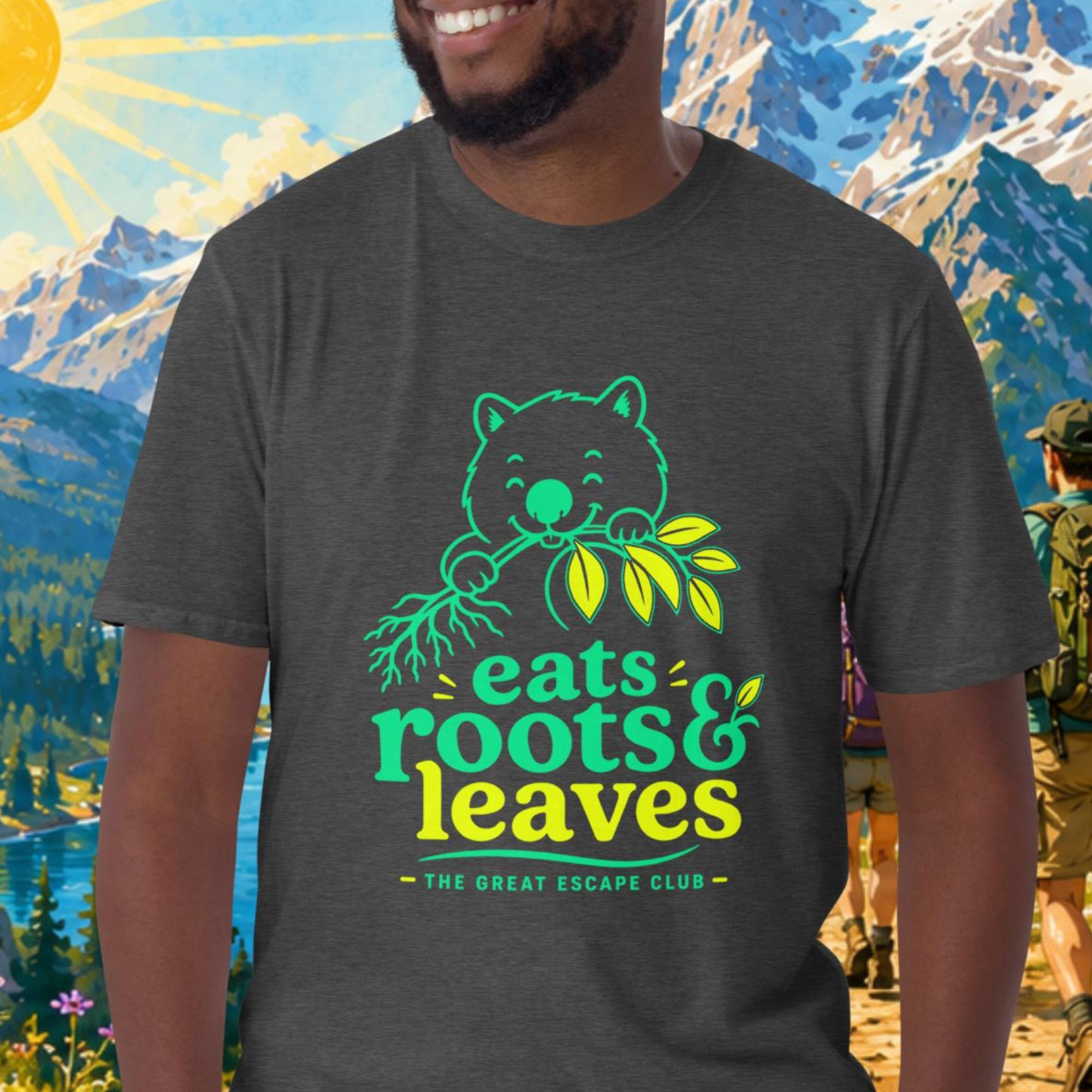 Man wearing a t-shirt with a bear graphic and text, standing in front of a scenic mountain landscape.