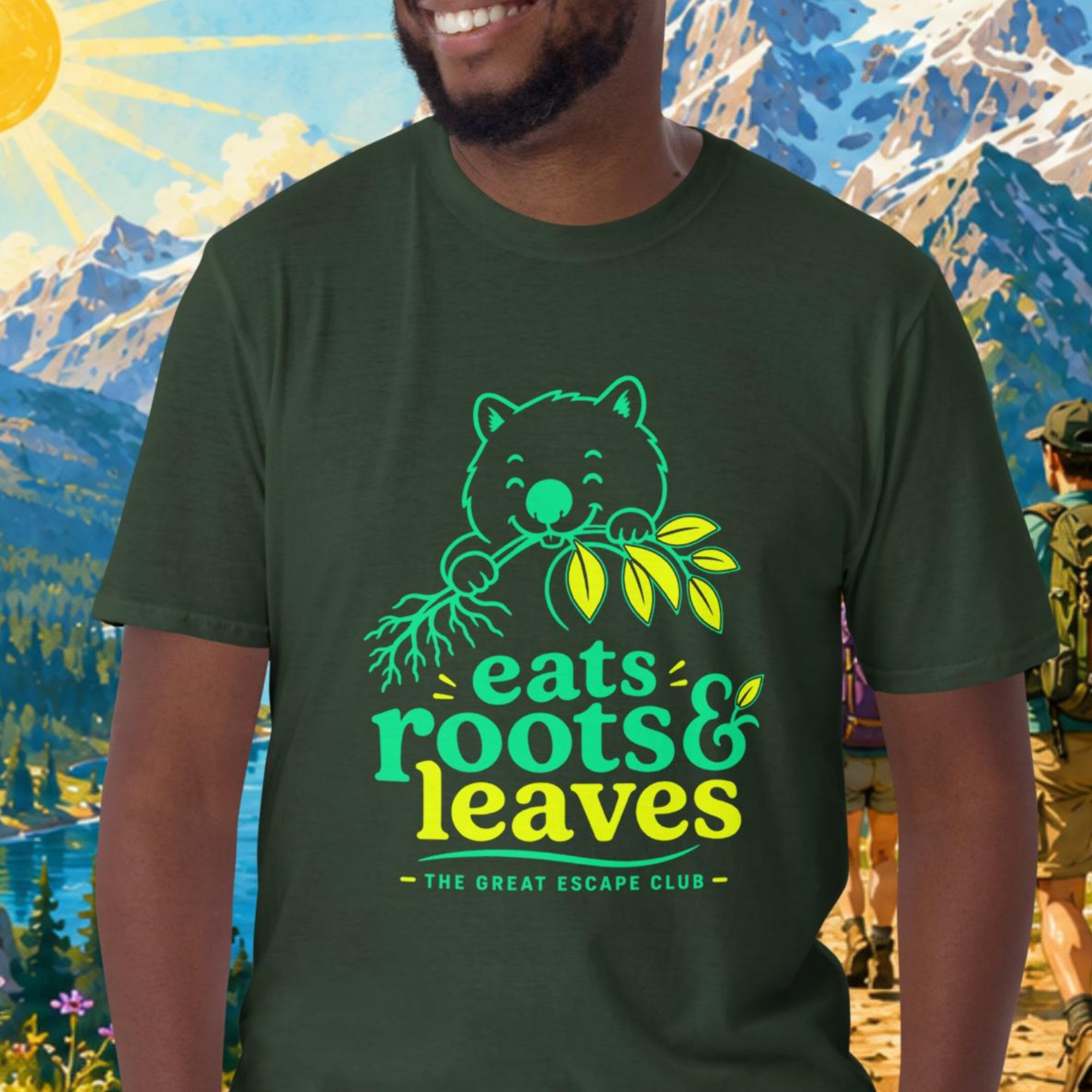 Man wearing a green t-shirt with a bear graphic and text, standing in front of a scenic mountain landscape.