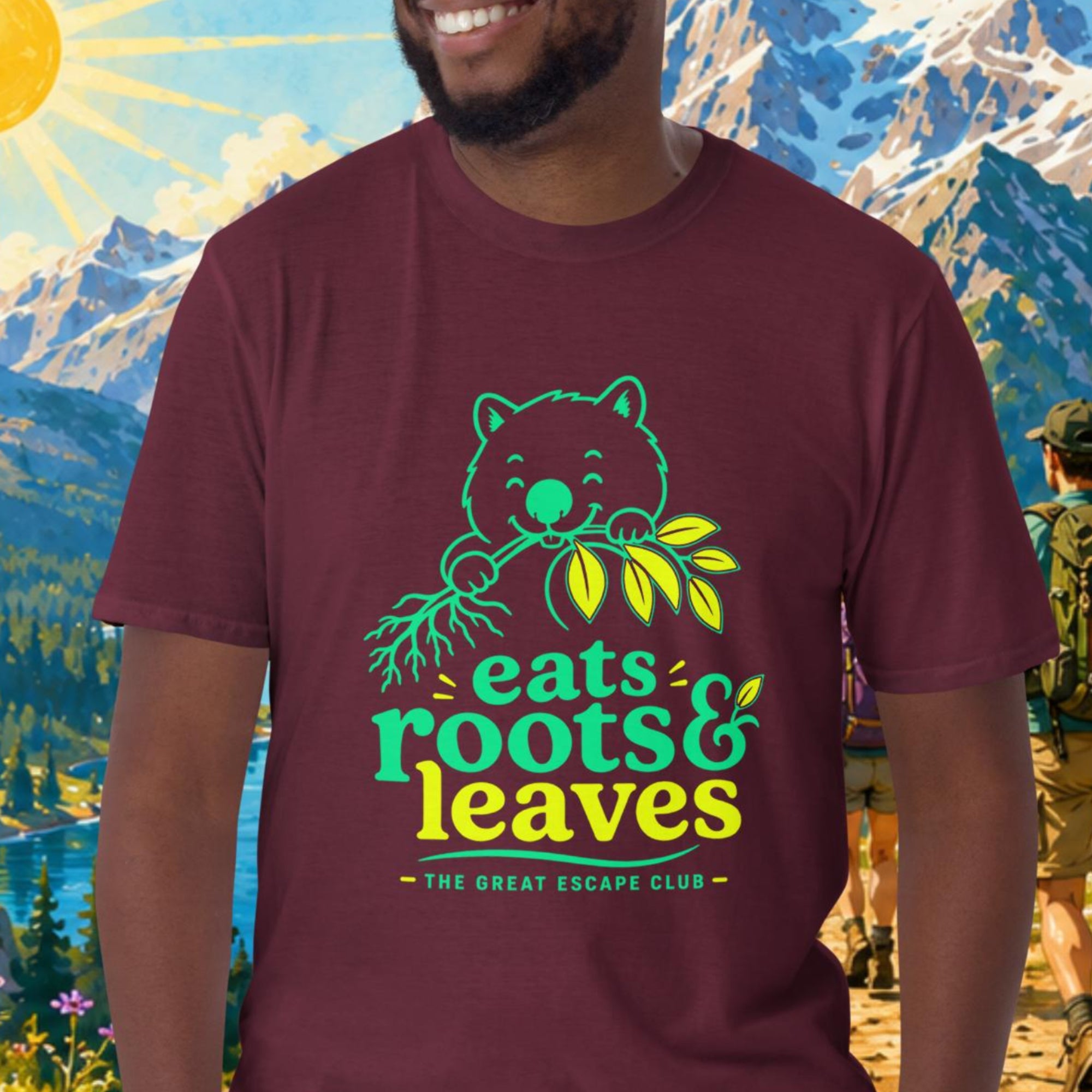 Man wearing a t-shirt with a nature-themed design in front of a mountainous landscape.