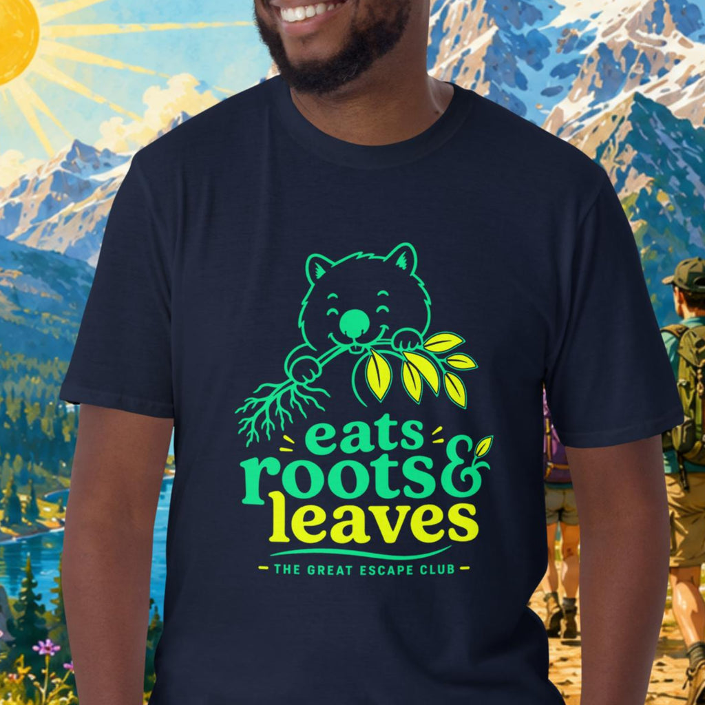 Man wearing a navy blue t-shirt with a bear graphic and text, standing in front of a scenic mountain backdrop with hikers.
