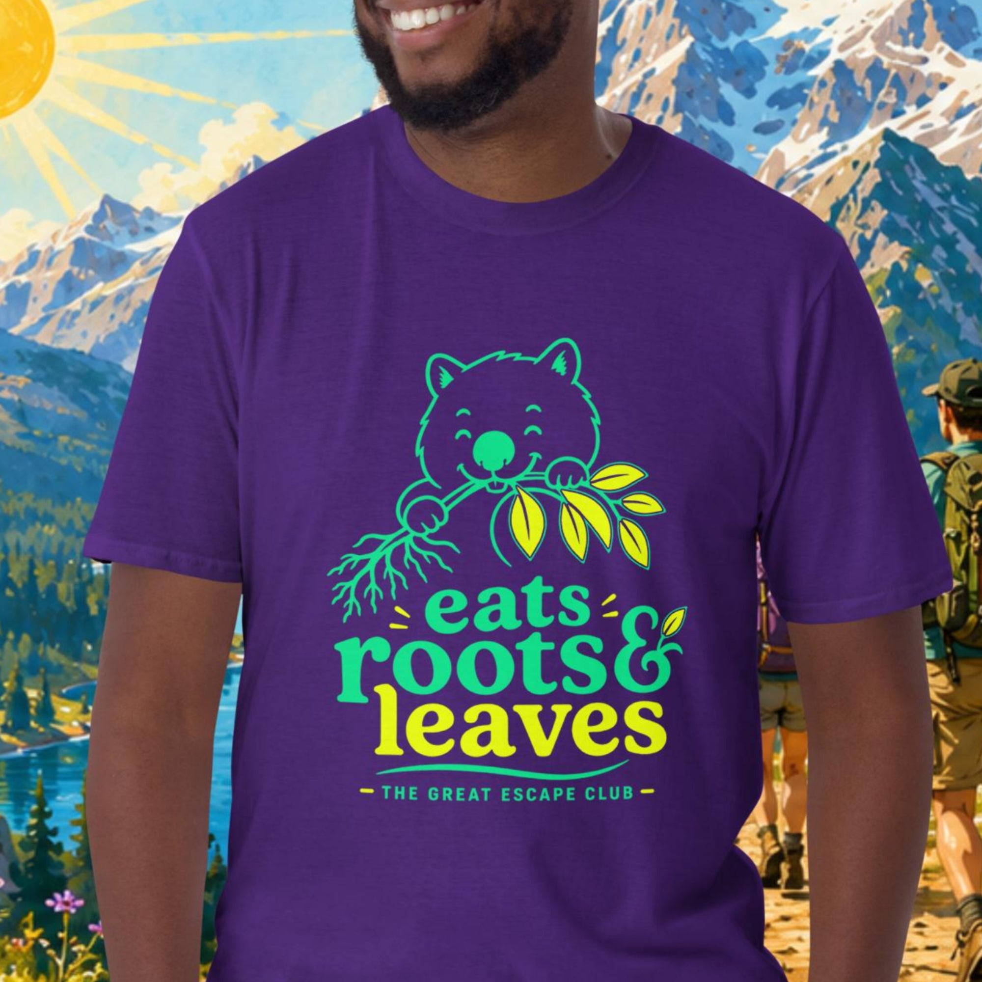 Man wearing a purple t-shirt with a bear graphic and text, standing in front of a scenic mountain landscape.