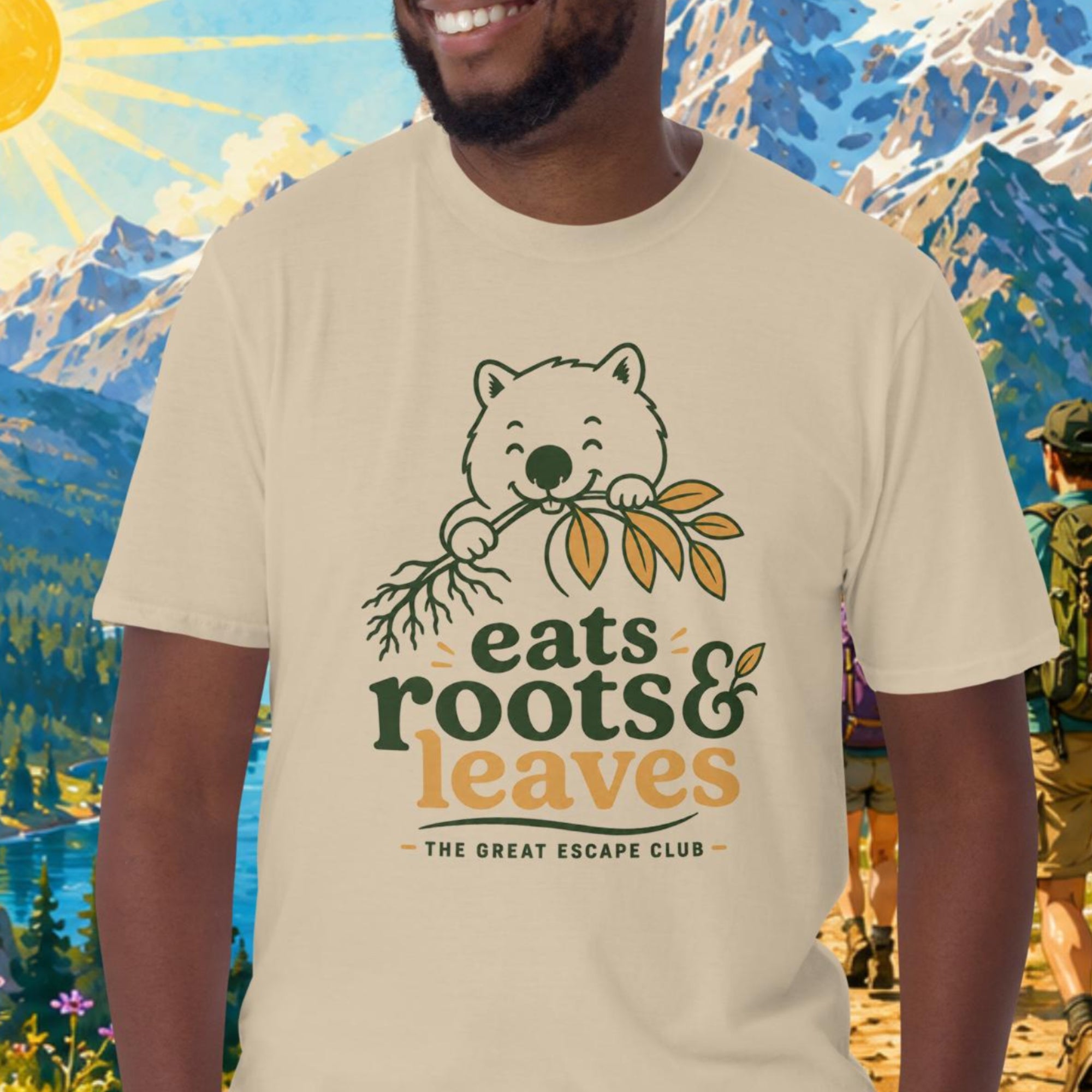 Man wearing a t-shirt with a bear graphic and text in front of a mountainous landscape.