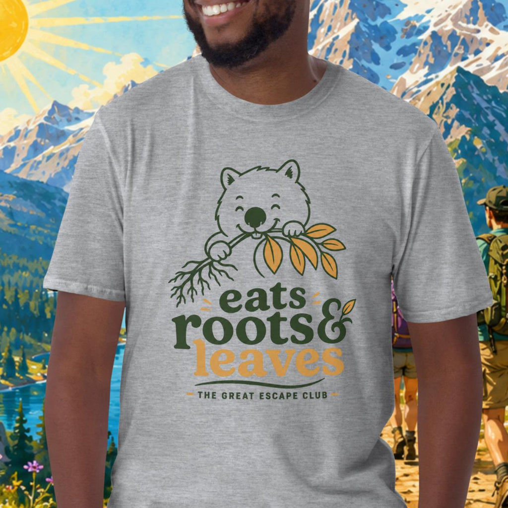 Man wearing a t-shirt with a bear graphic and text, standing in front of a scenic mountain landscape.
