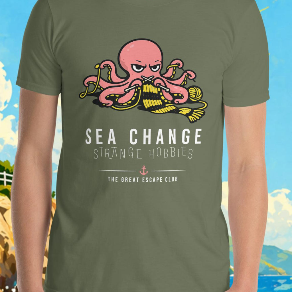 Person wearing a t-shirt with an octopus design and text, standing in front of a scenic background with a lighthouse and sailboat.