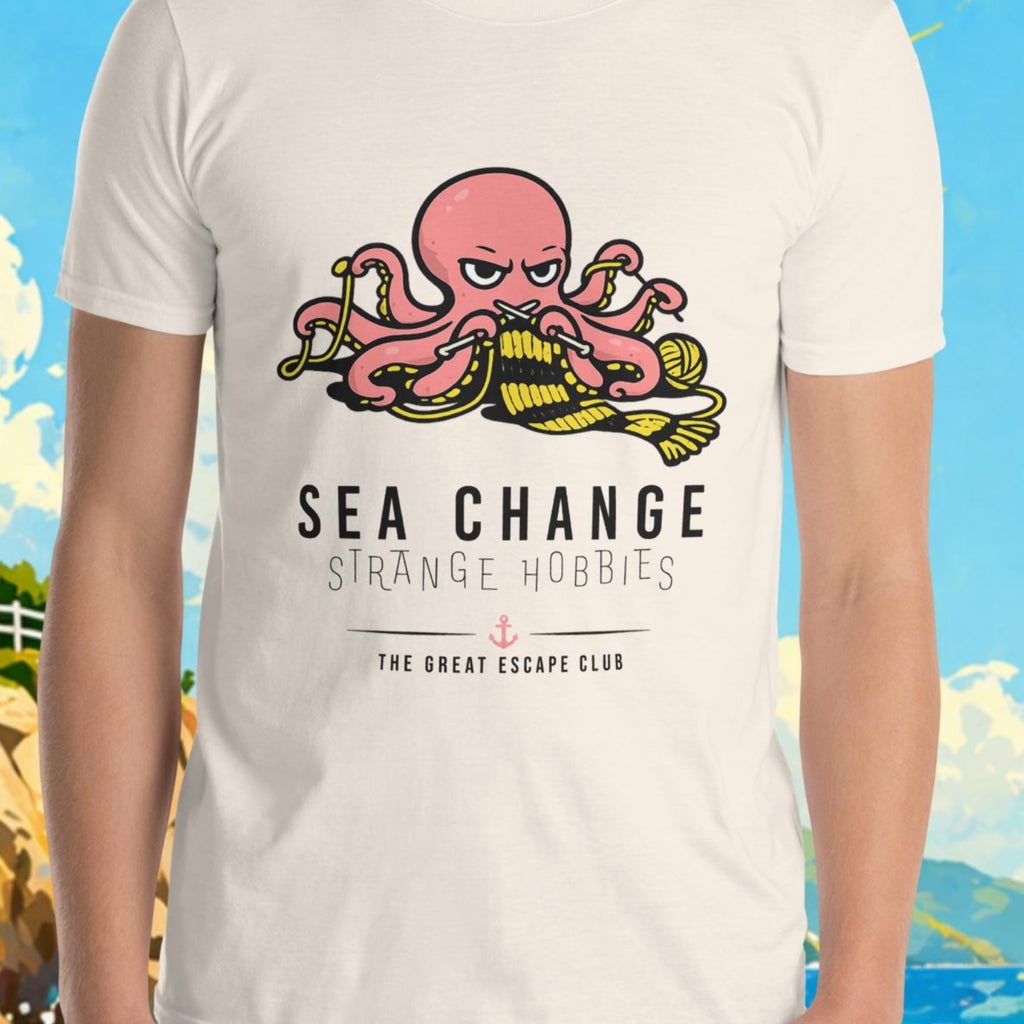 Person wearing a t-shirt with an octopus design and text, set against a scenic background with a lighthouse and boat.