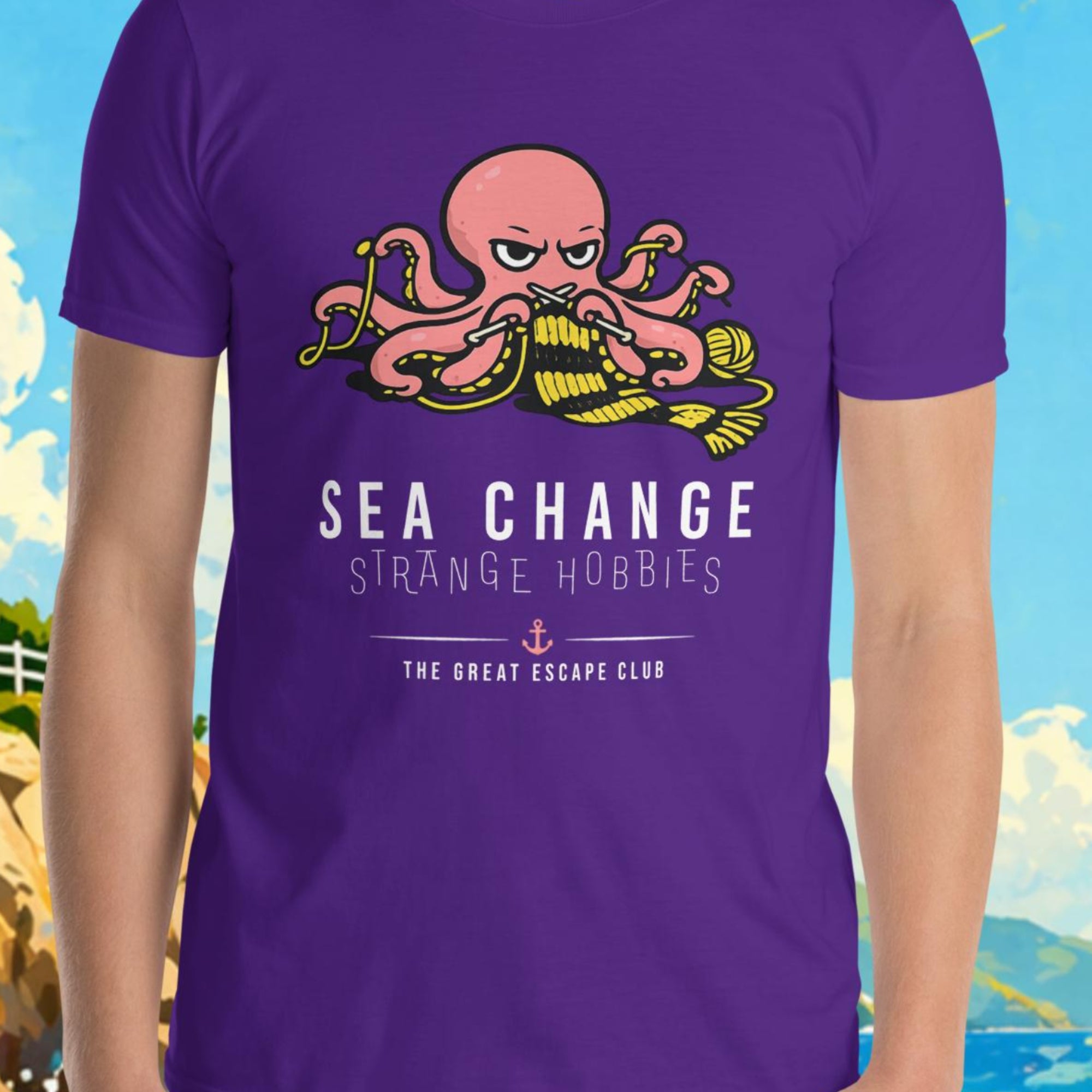 Person wearing a purple t-shirt with an octopus design and text, standing in front of a scenic background with a lighthouse and sailboat.