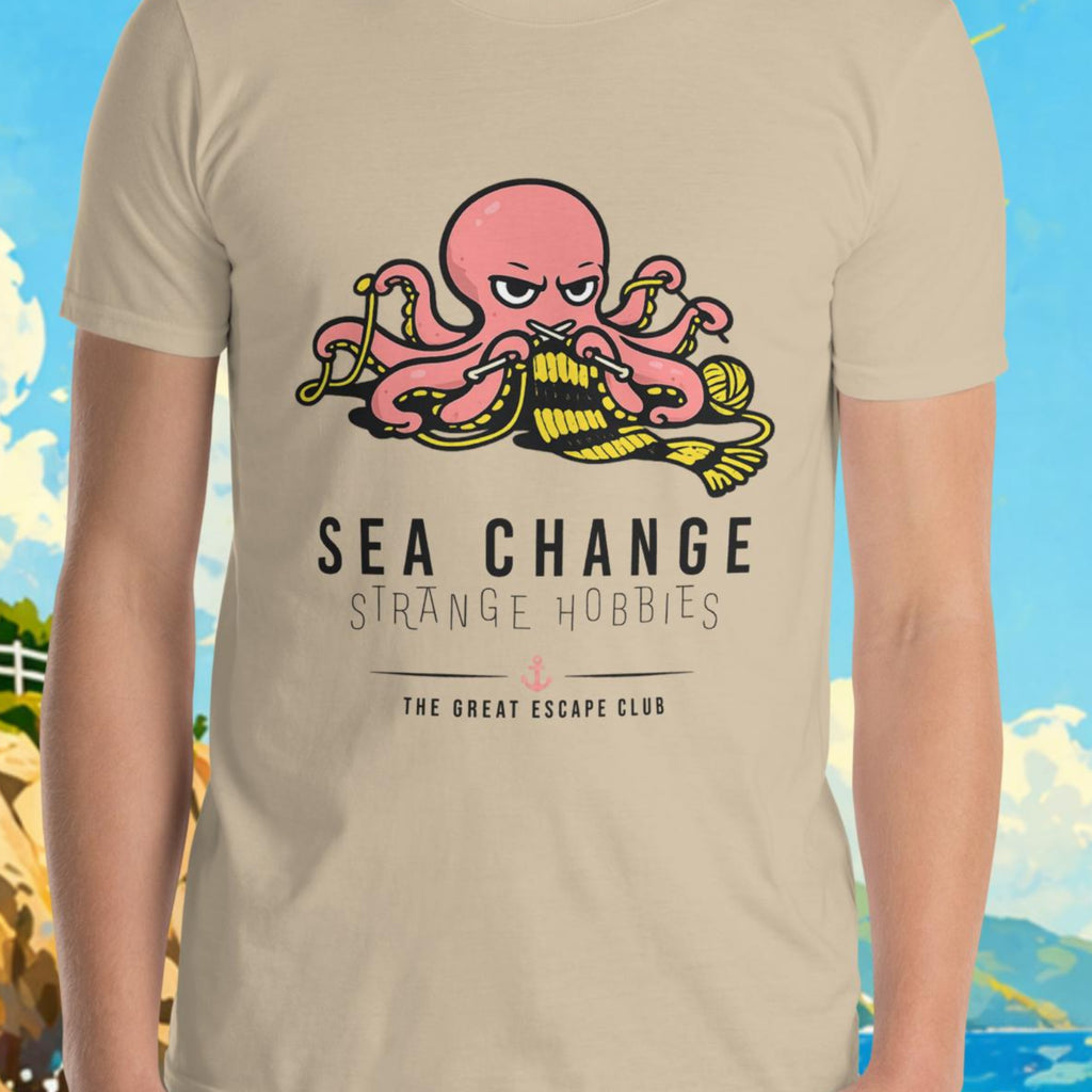 Person wearing a t-shirt with a graphic design in front of a scenic background with a lighthouse and sailboat.