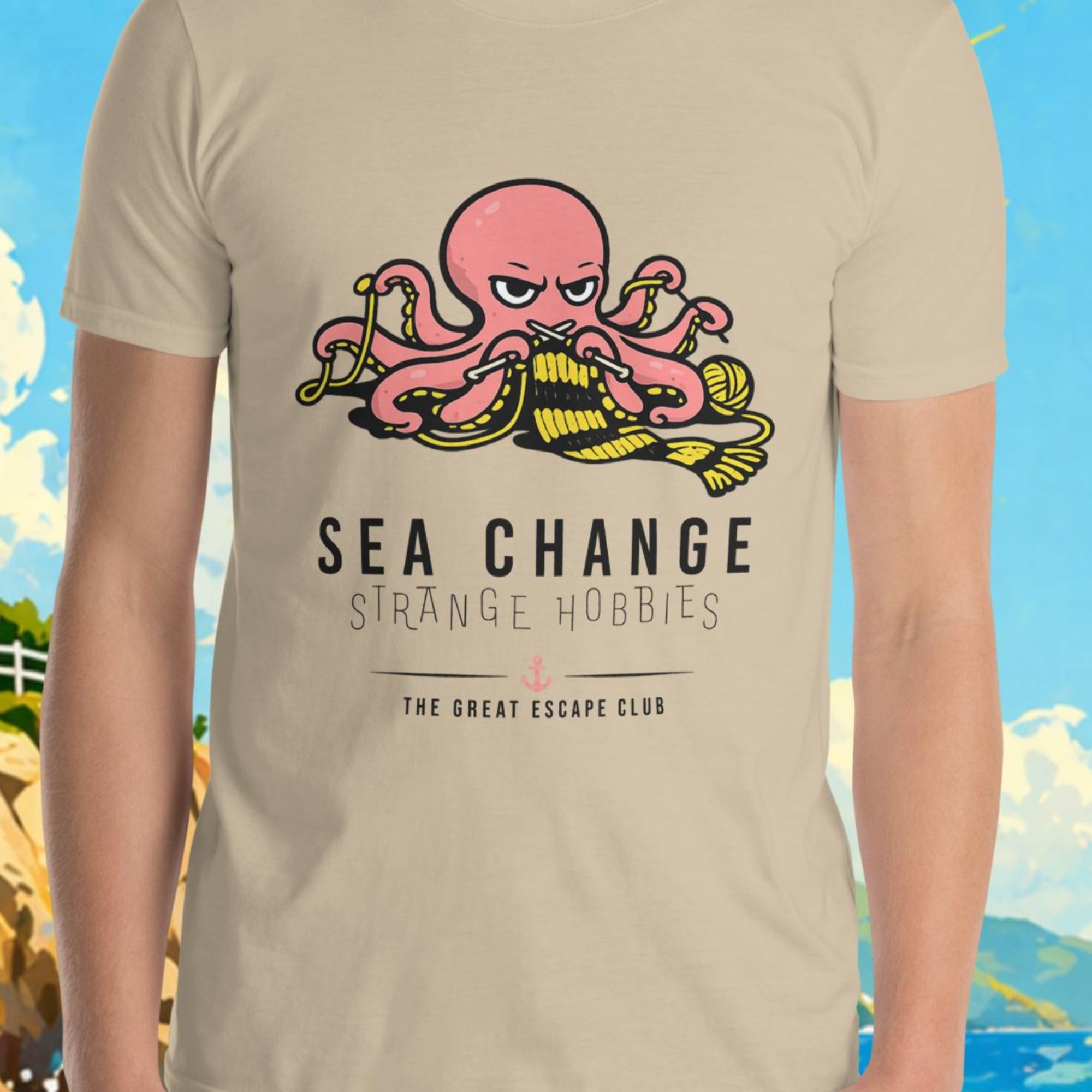 Person wearing a t-shirt with a graphic design in front of a scenic background with a lighthouse and sailboat.