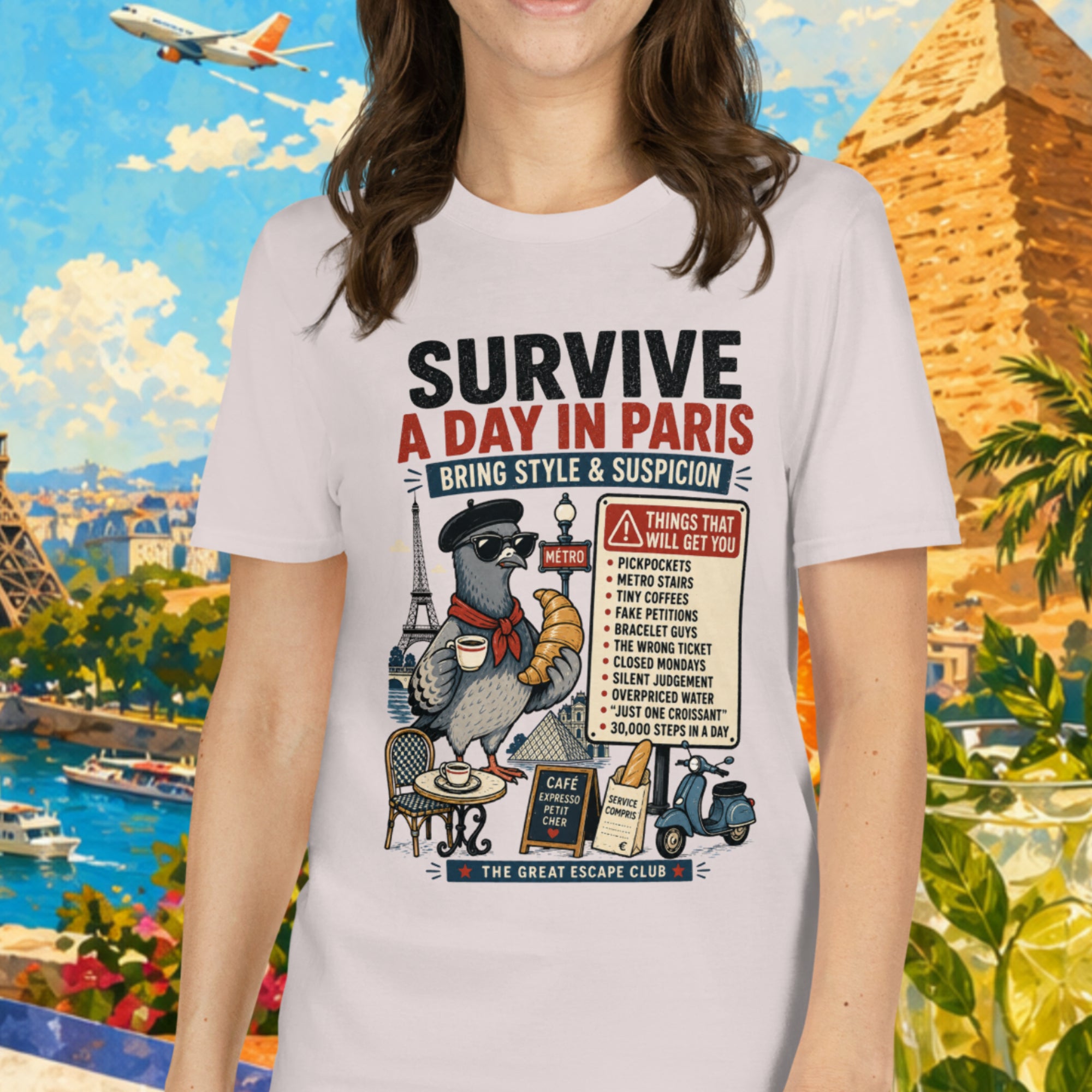 Woman wearing a t-shirt with travel-themed design in front of a scenic background with Eiffel Tower and pyramids.