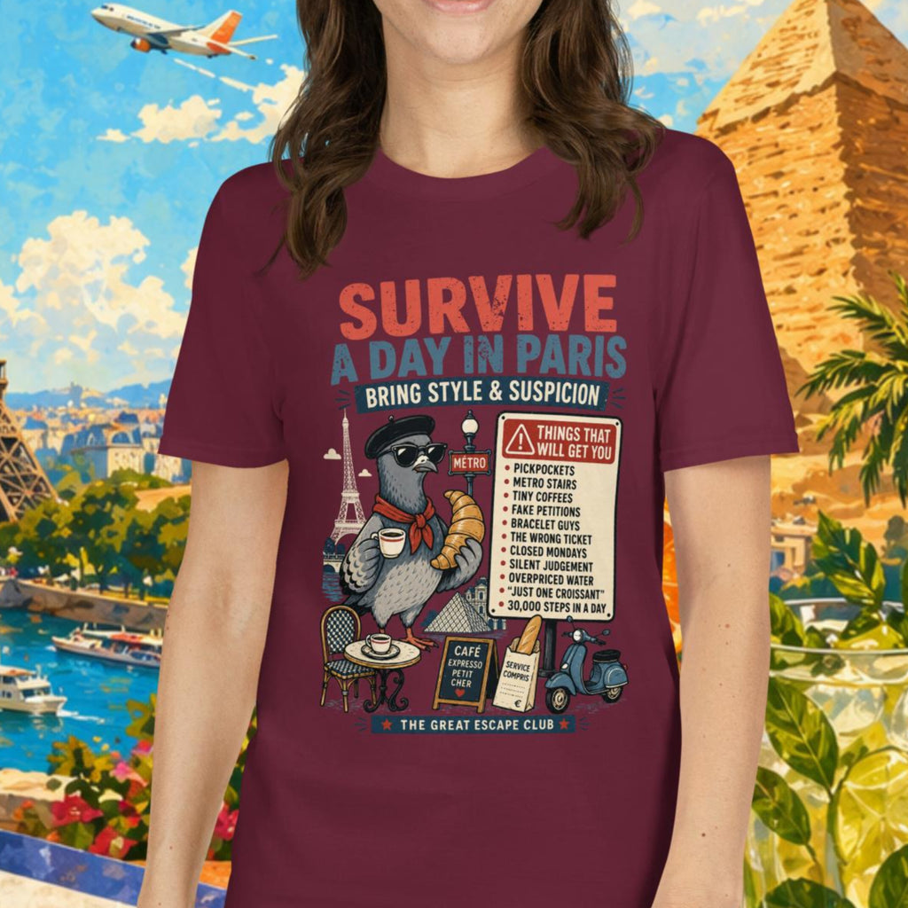 Survive a Day in Paris unisex T-shirt in maroon featuring a funny Paris pigeon travel graphic with croissant, espresso and warning sign design.
