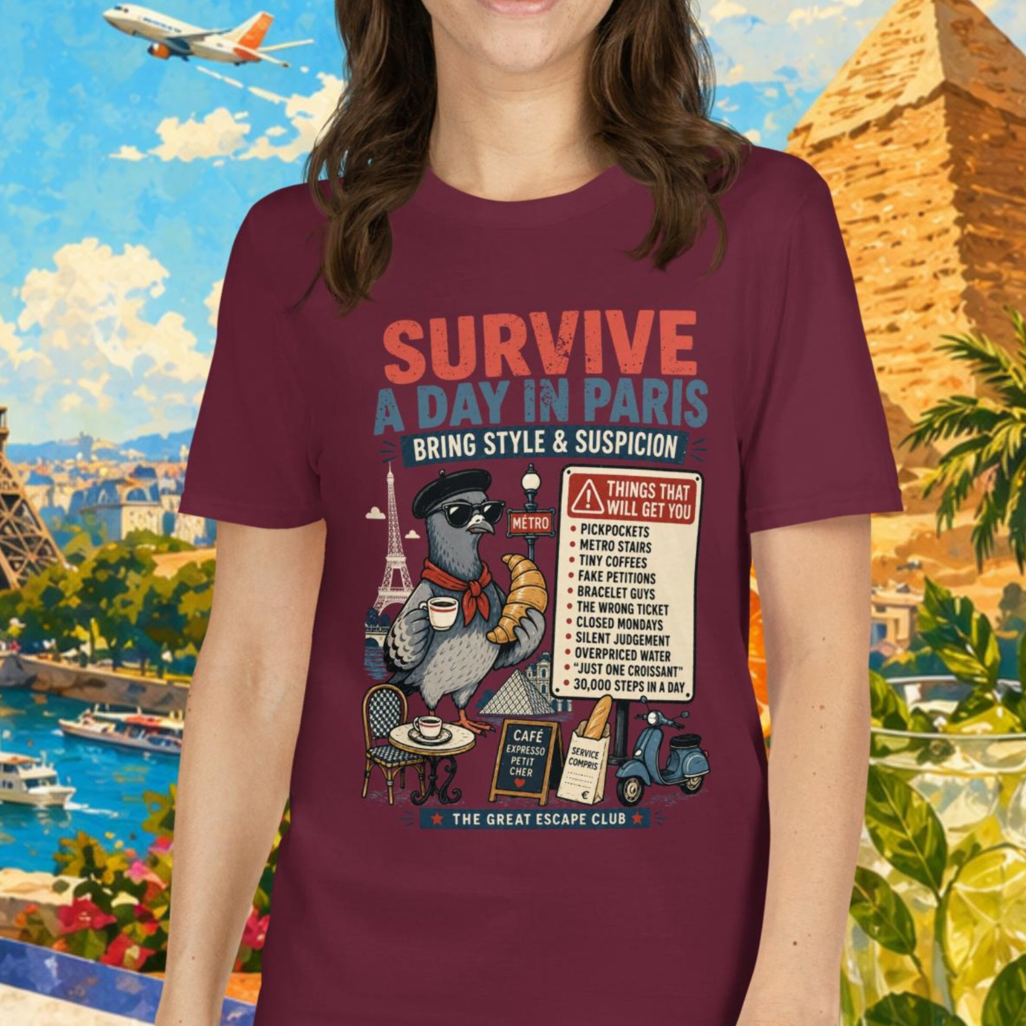 Survive a Day in Paris unisex T-shirt in maroon featuring a funny Paris pigeon travel graphic with croissant, espresso and warning sign design.