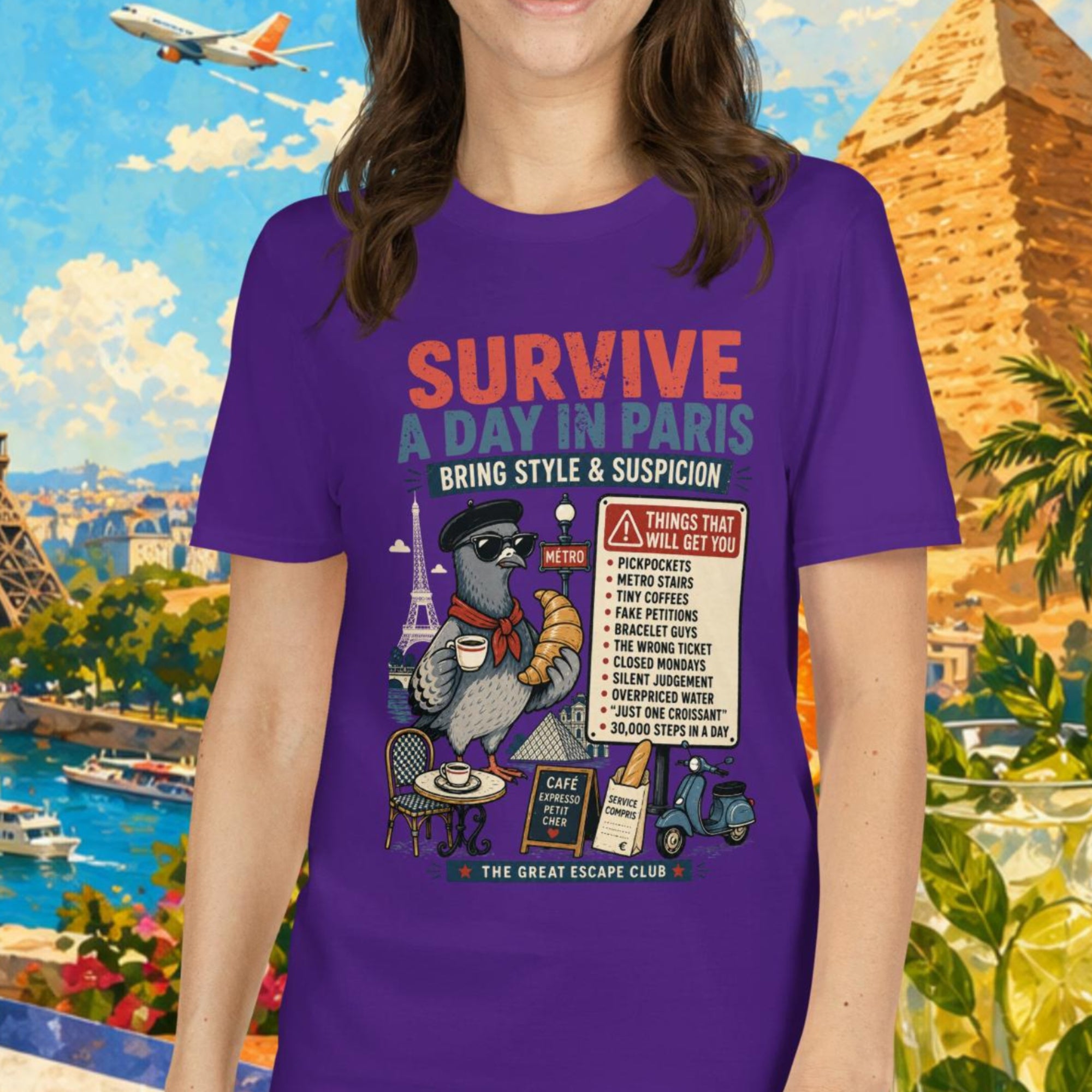 Survive a Day in Paris unisex T-shirt in purple featuring a funny Paris pigeon travel graphic with croissant, espresso and warning sign design.