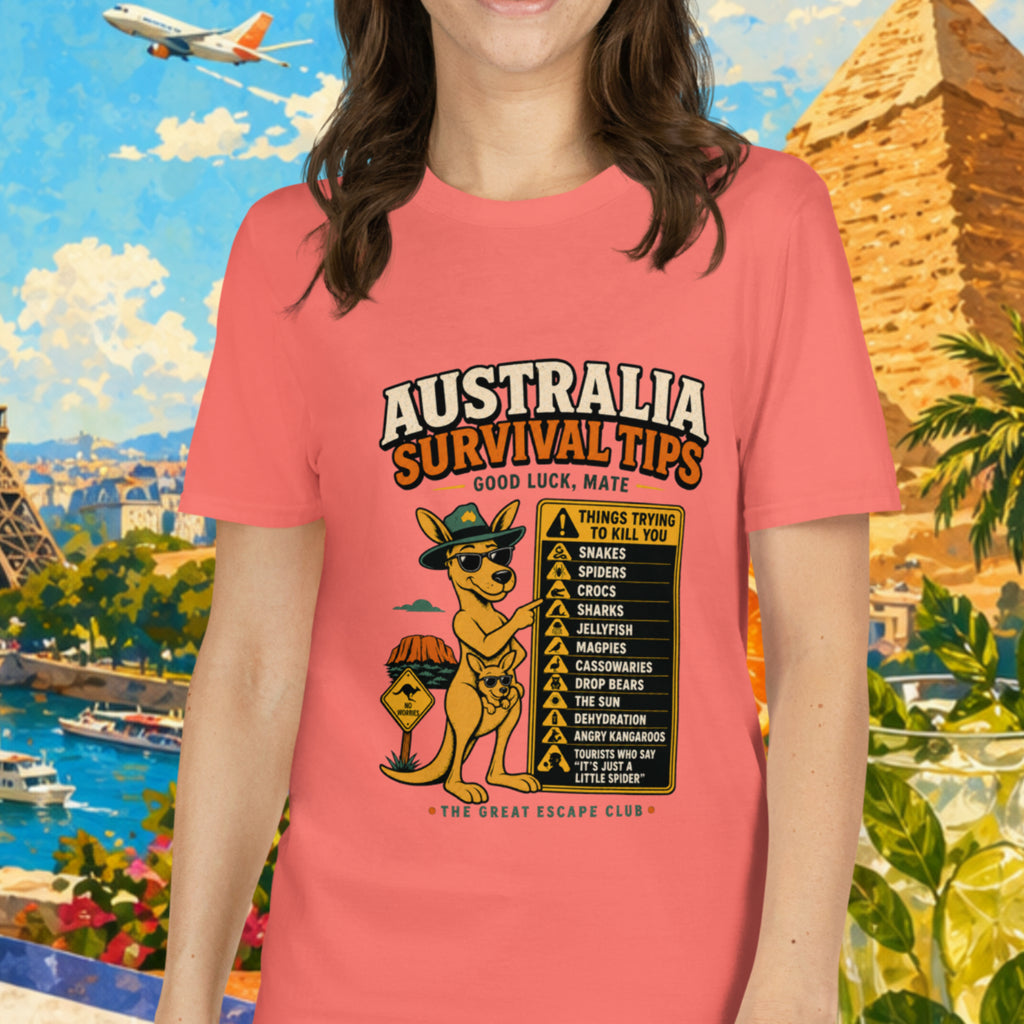 Woman wearing a pink t-shirt with 'Australia Survival Tips' design, standing in front of travel-themed background with Eiffel Tower and pyramids.