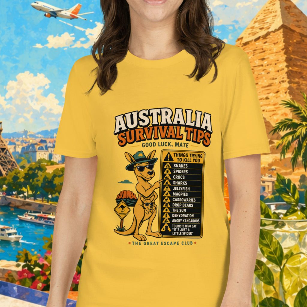 Woman wearing a yellow t-shirt with 'Australia Survival Tips' design, standing in front of a colorful background with landmarks and tropical elements.