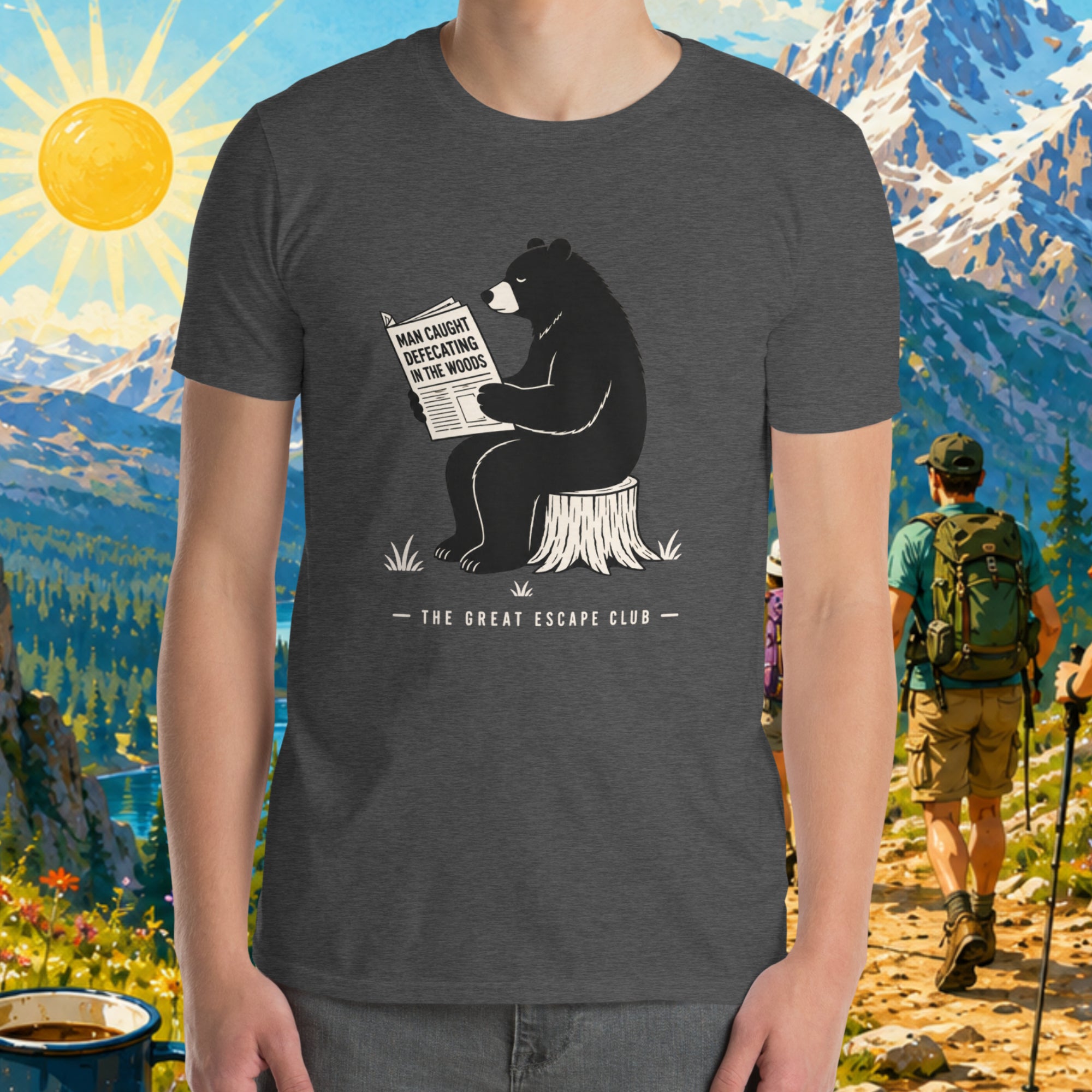 Person wearing a t-shirt with a bear graphic and text, set against a scenic mountain backdrop.