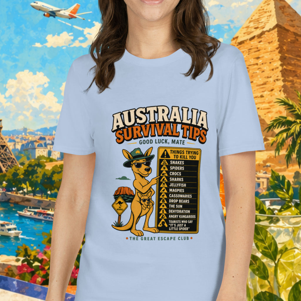 Woman wearing a t-shirt with 'Australia Survival Tips' design, standing in front of a colorful travel-themed background.