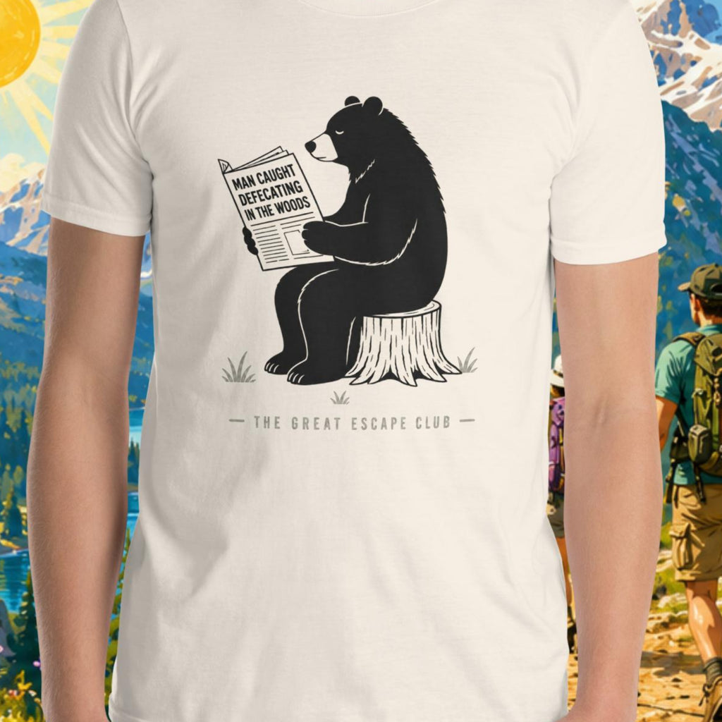 Person wearing a t-shirt with a bear graphic and text, set against a scenic mountain backdrop.