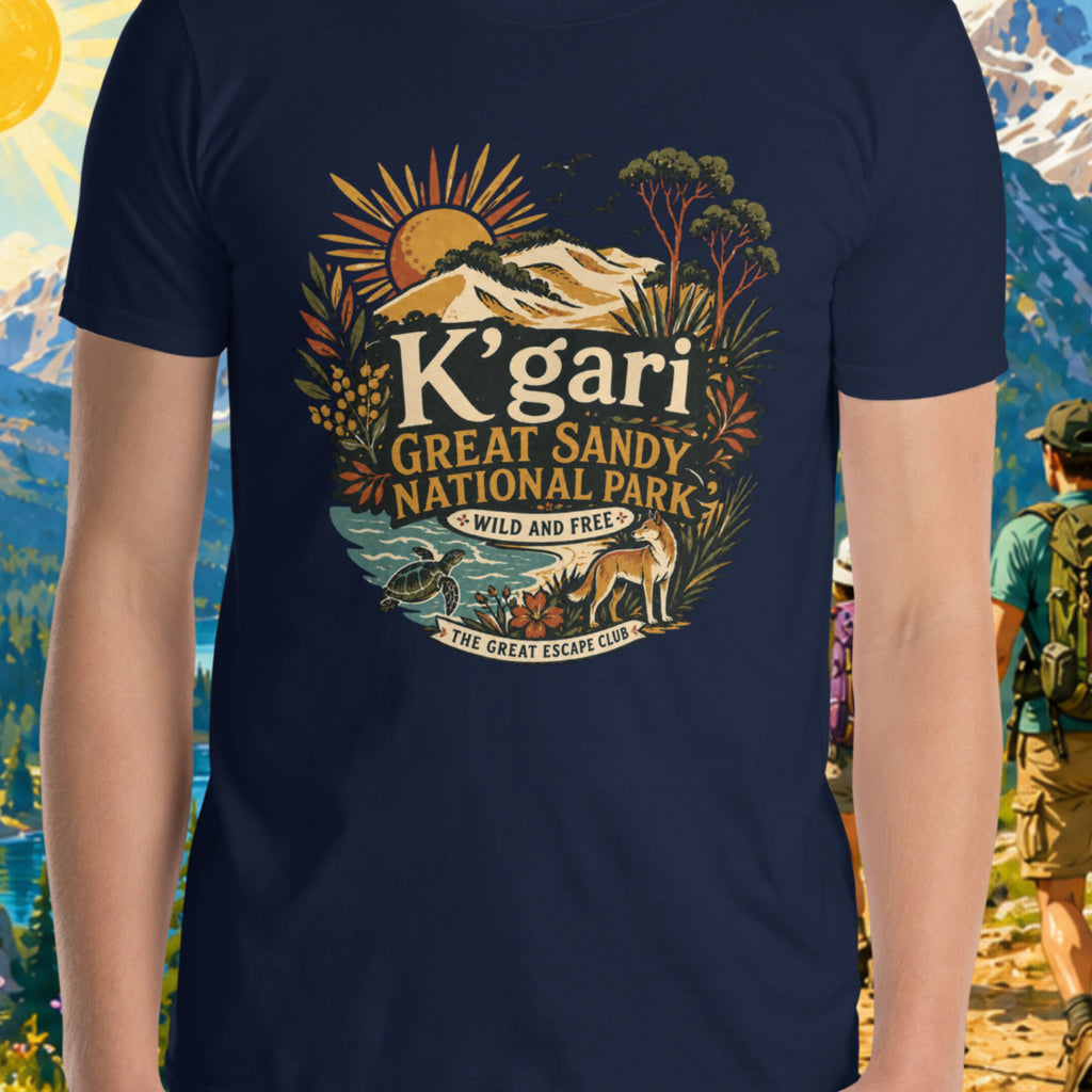 Person wearing a navy blue t-shirt with 'K'gari Great Sandy National Park' design, standing in front of a scenic mountain backdrop.