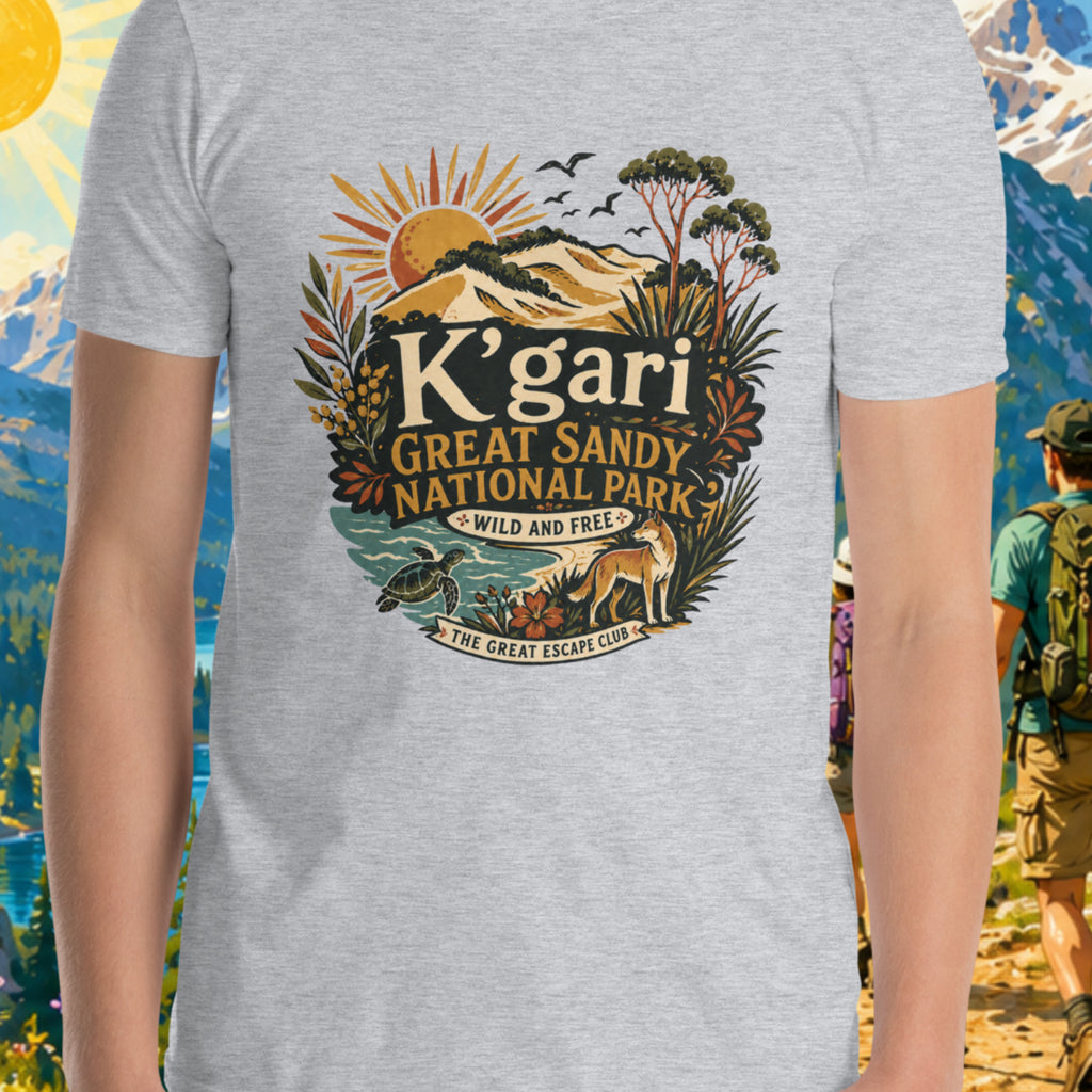 Person wearing a t-shirt with 'K'gari Great Sandy National Park' design against a scenic mountain backdrop.