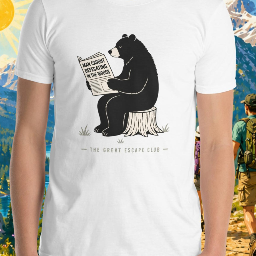 Person wearing a white t-shirt with a bear graphic and text, set against a scenic mountain backdrop.