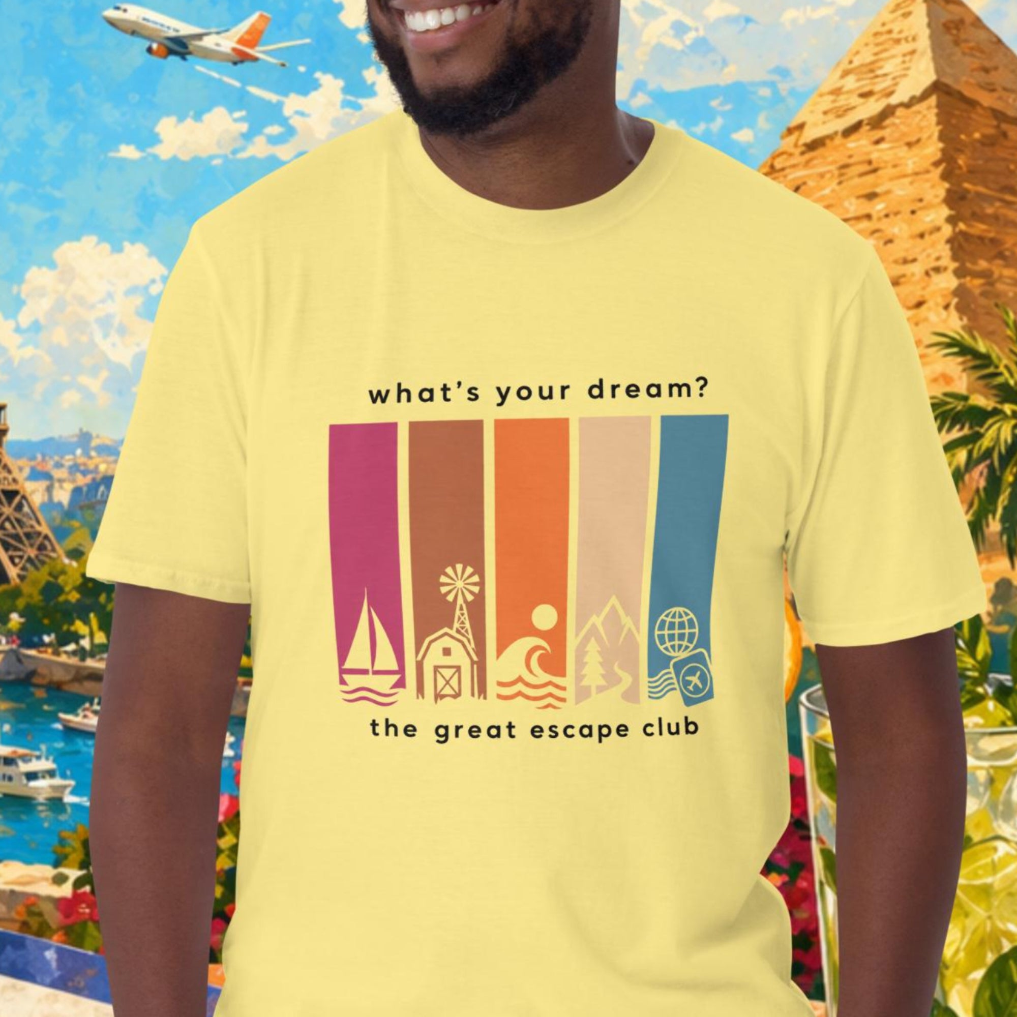 Man wearing a yellow t-shirt with travel-themed design in front of a scenic background with Eiffel Tower, pyramids, and tropical elements.