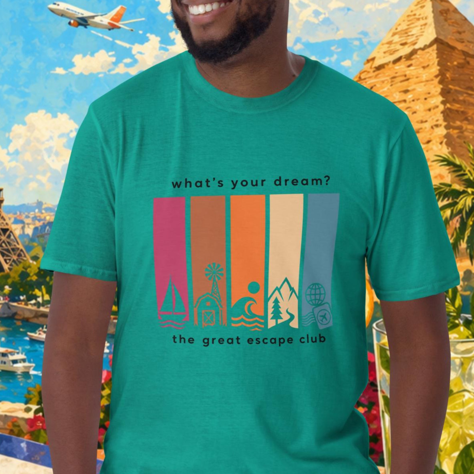 Man wearing a teal t-shirt with a colorful graphic design in front of a scenic background with Eiffel Tower, pyramids, and tropical elements.