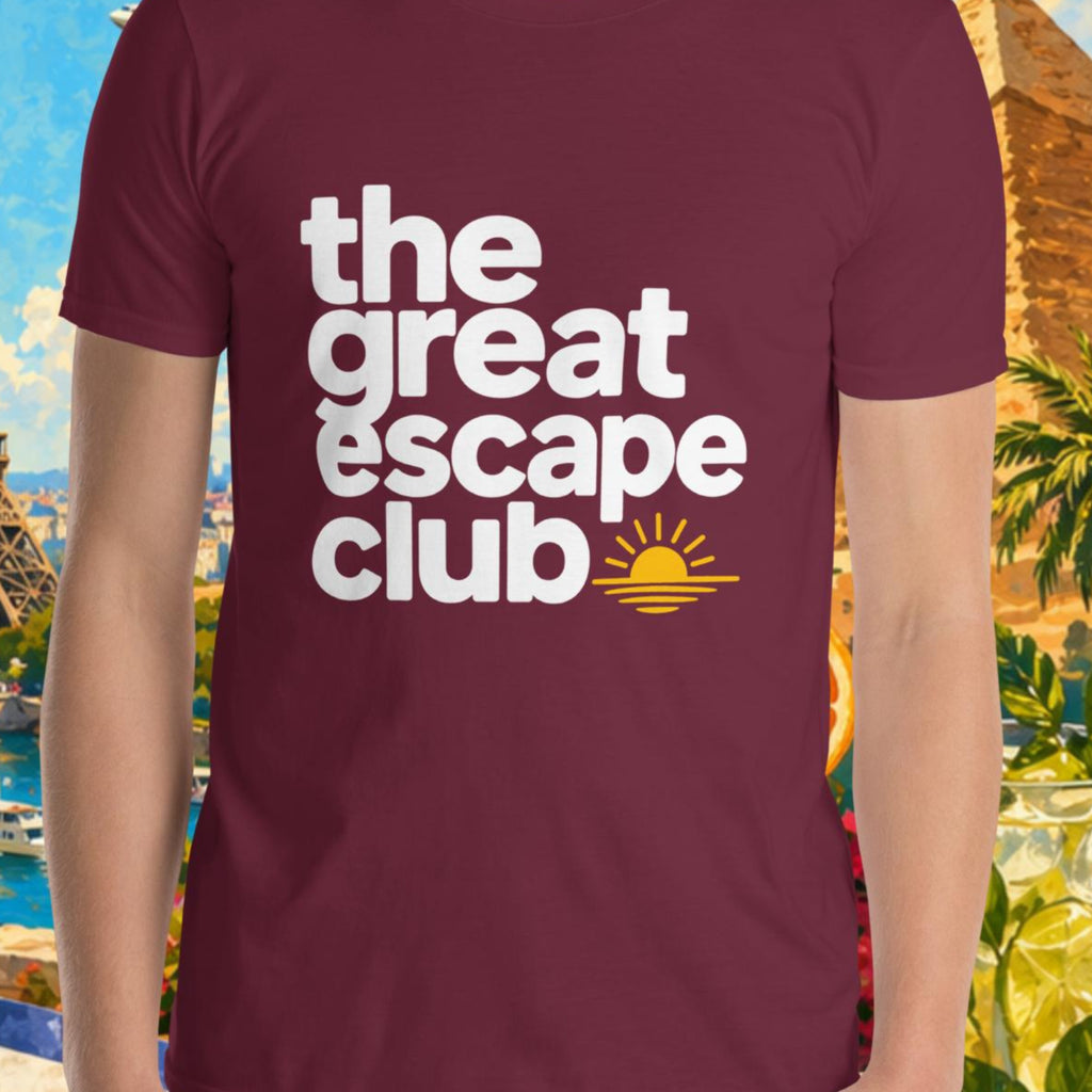 Person wearing a maroon t-shirt with 'the great escape club' text, set against a colorful travel-themed background.