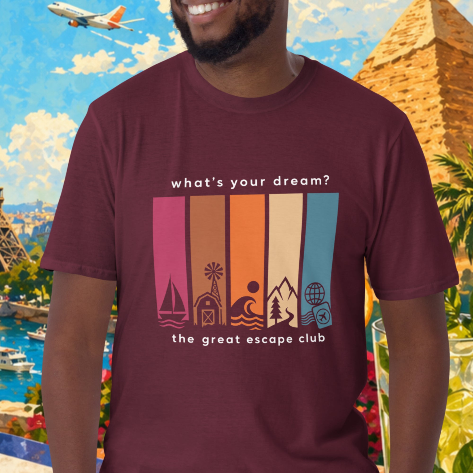 Man wearing a t-shirt with a travel-themed design in front of a colorful background with landmarks and nature.