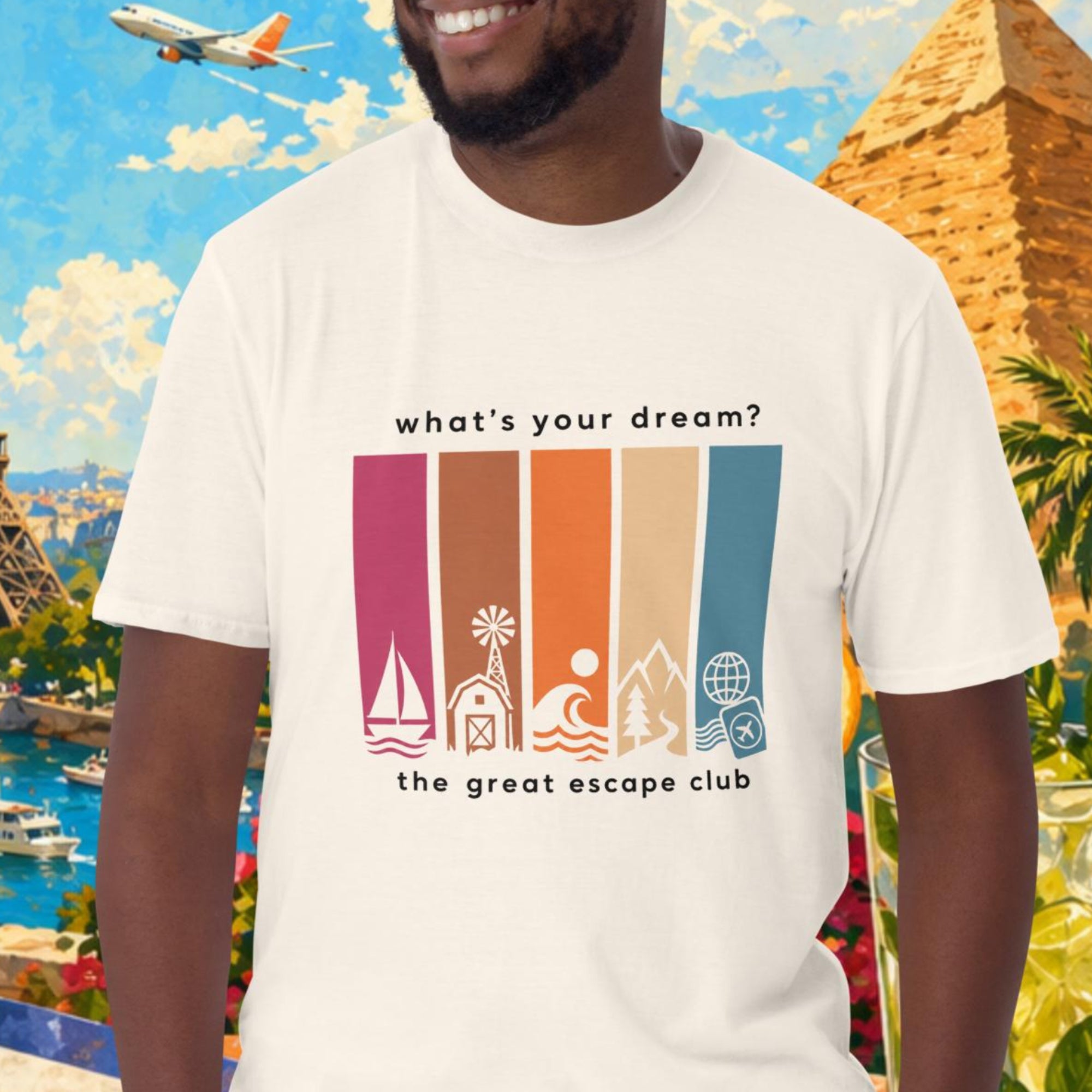 Man wearing a t-shirt with travel-themed design in front of a colorful background with landmarks and travel items.